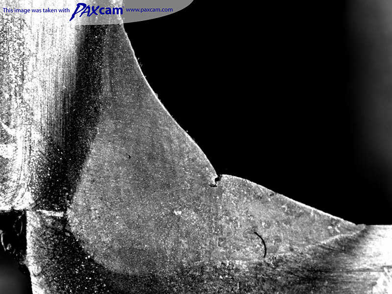 Weld section under welding inspection microscope. Weld section under welding inspection microscope.